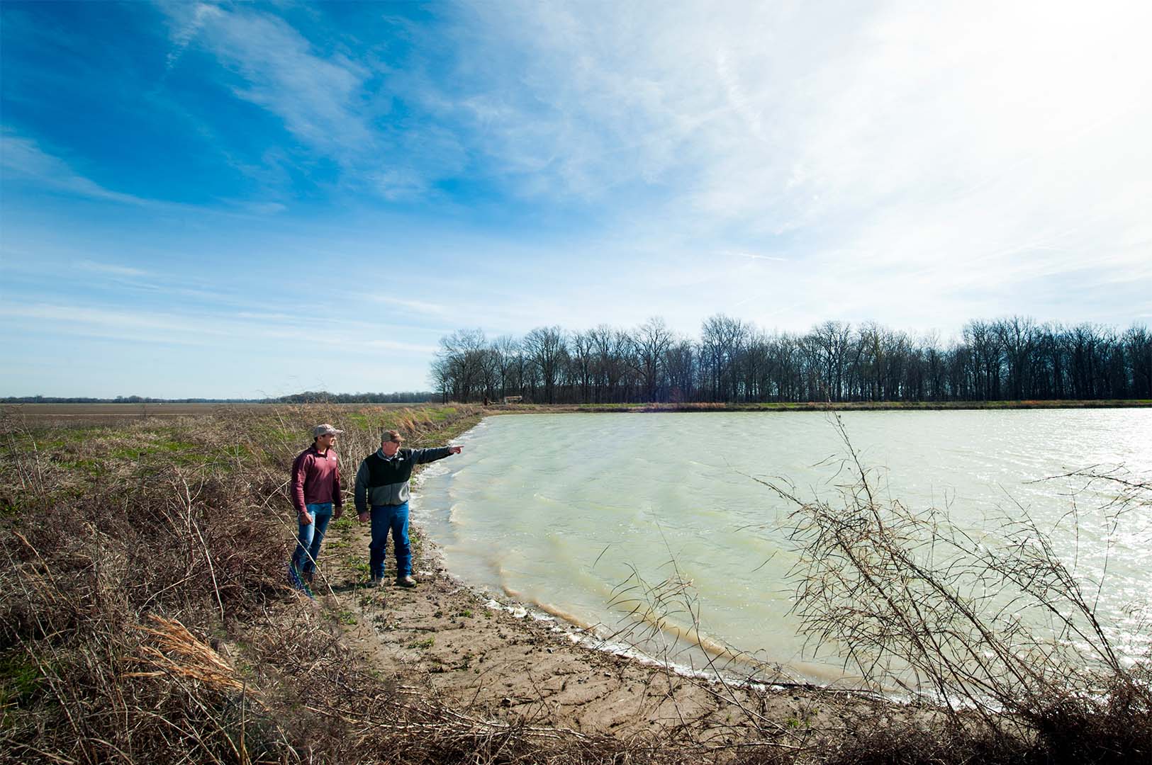 Graduate student Juan Prez-Gutirrez alongside Boyer Britt, manager of Shivers Farm, near Indianola, Mississippi, discuss on-farm water storage. (Photo by Russ Houston)