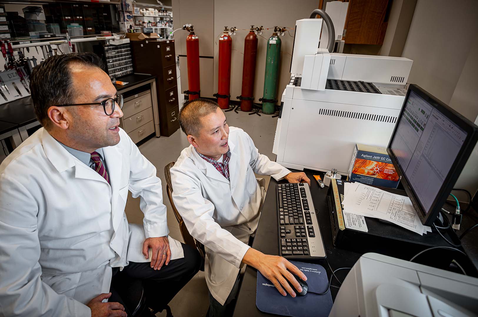 Drs. Erdogan Memili and Thu Dinh examine metabolites in bull sperm to determine potential fertility biomarkers. (Photo by David Ammon)